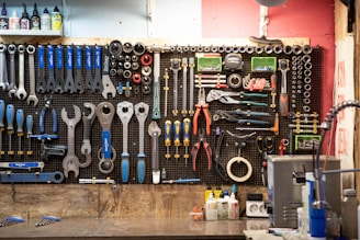 A bunch of tools hanging up on a wall
