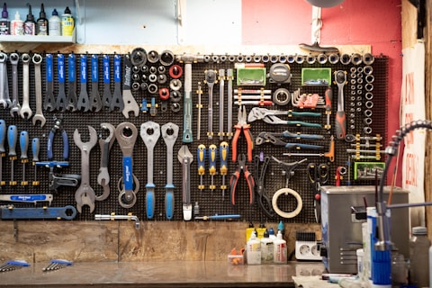 A bunch of tools hanging up on a wall