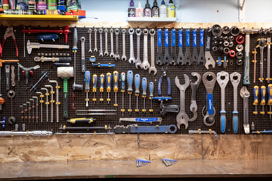 Wrenches and drivers hung in order on a pegboard above a plywood bench
