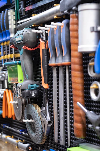 A bunch of tools are hanging on a wall