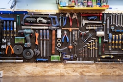 A bunch of tools hanging up on a wall