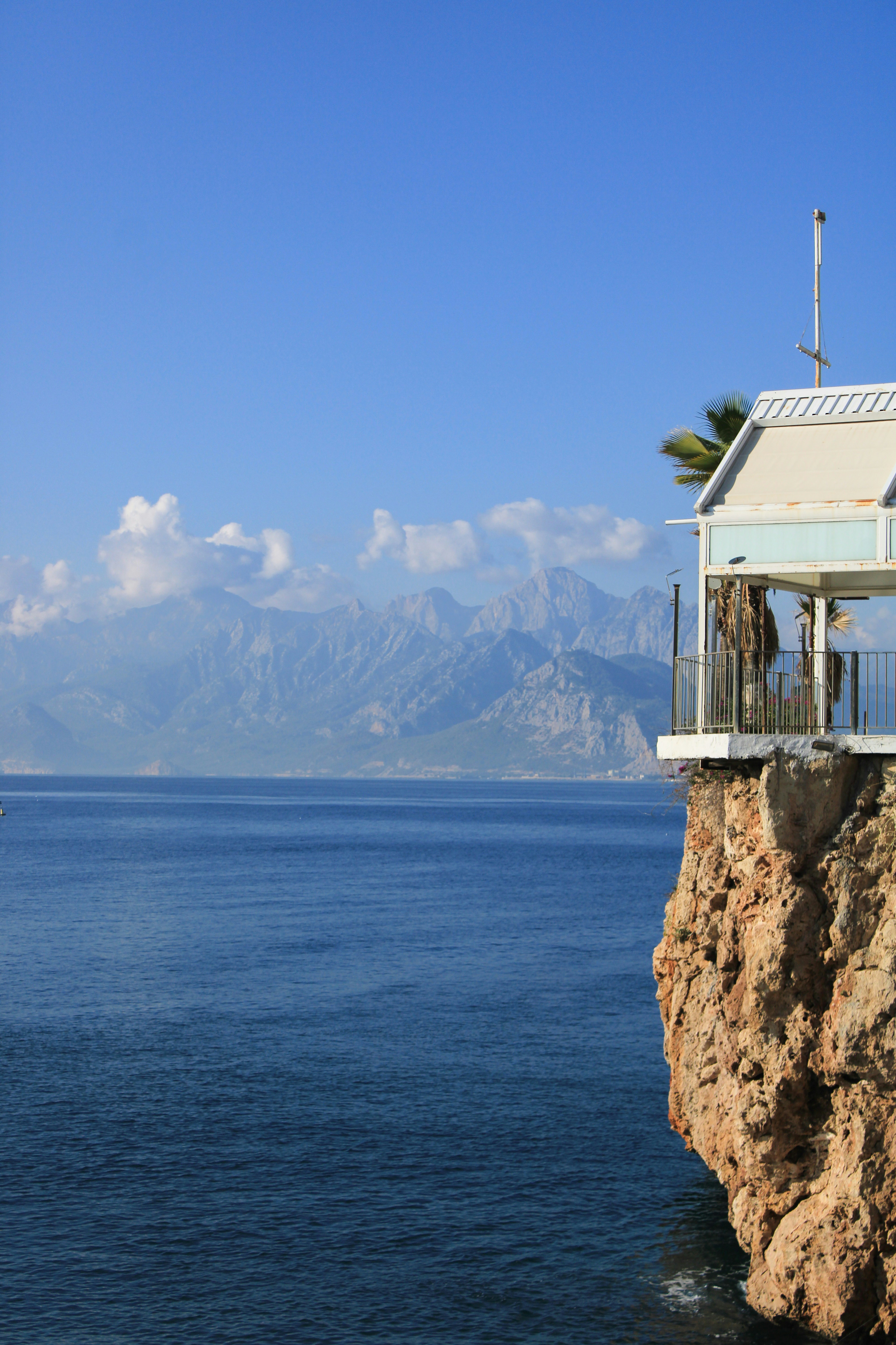 A house sitting on top of a cliff next to the ocean