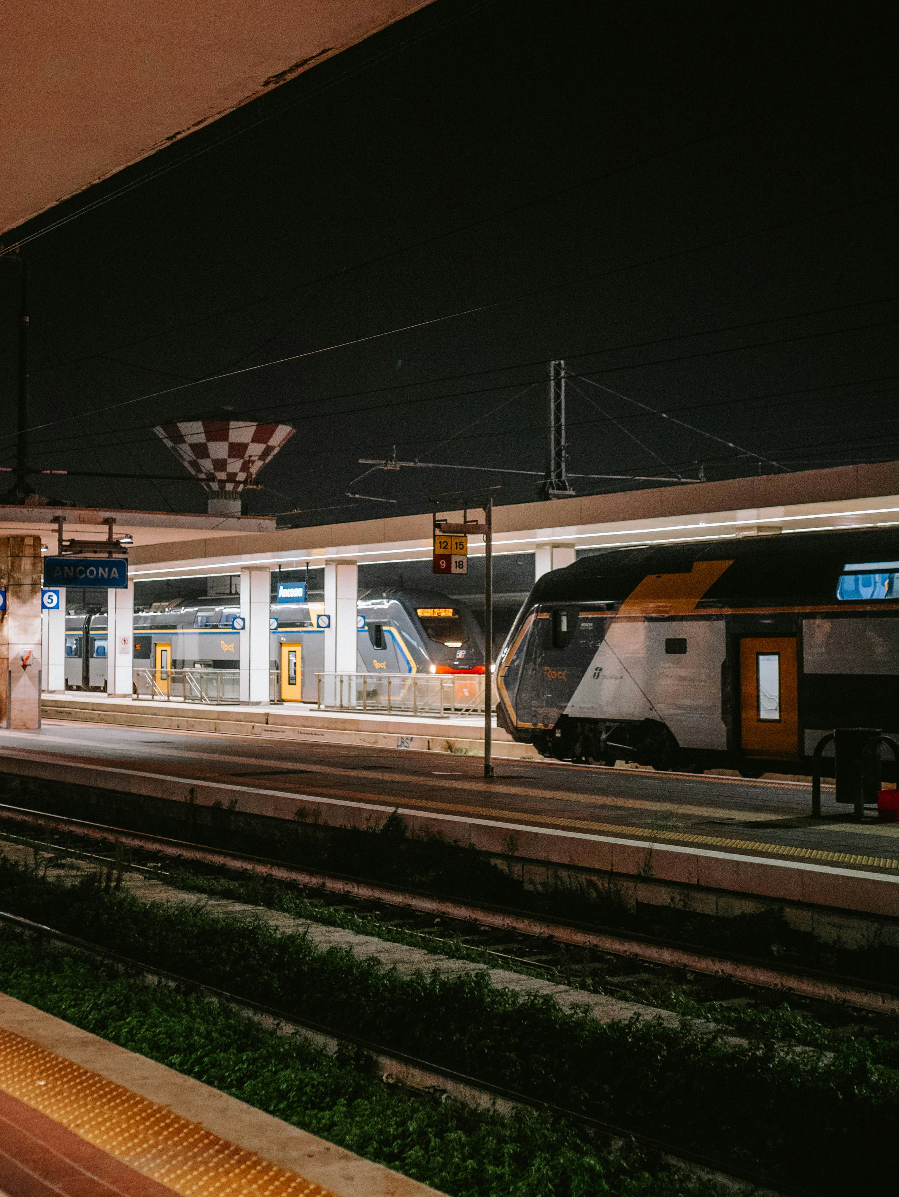 A train pulling into a train station at night