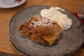 A piece of pie and whipped cream on a plate