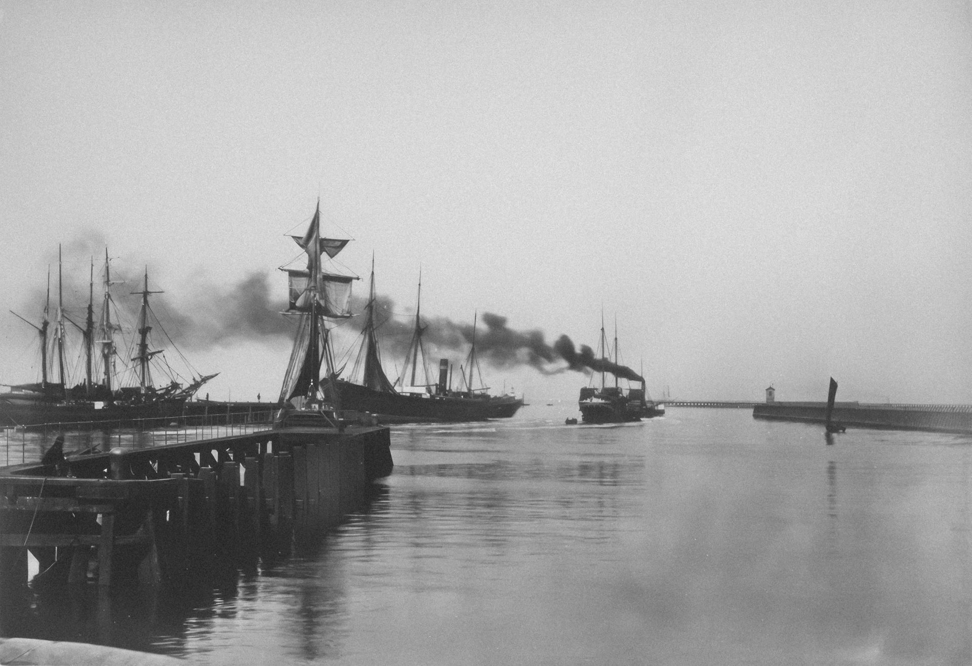 Steamships and sailing vessels in a harbor