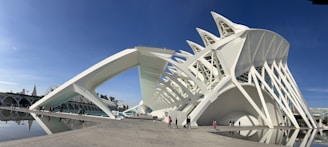 A large white building sitting next to a body of water
