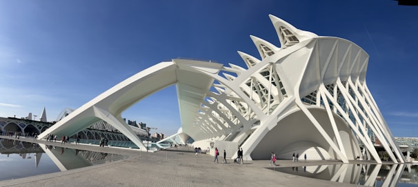 A large white building sitting next to a body of water