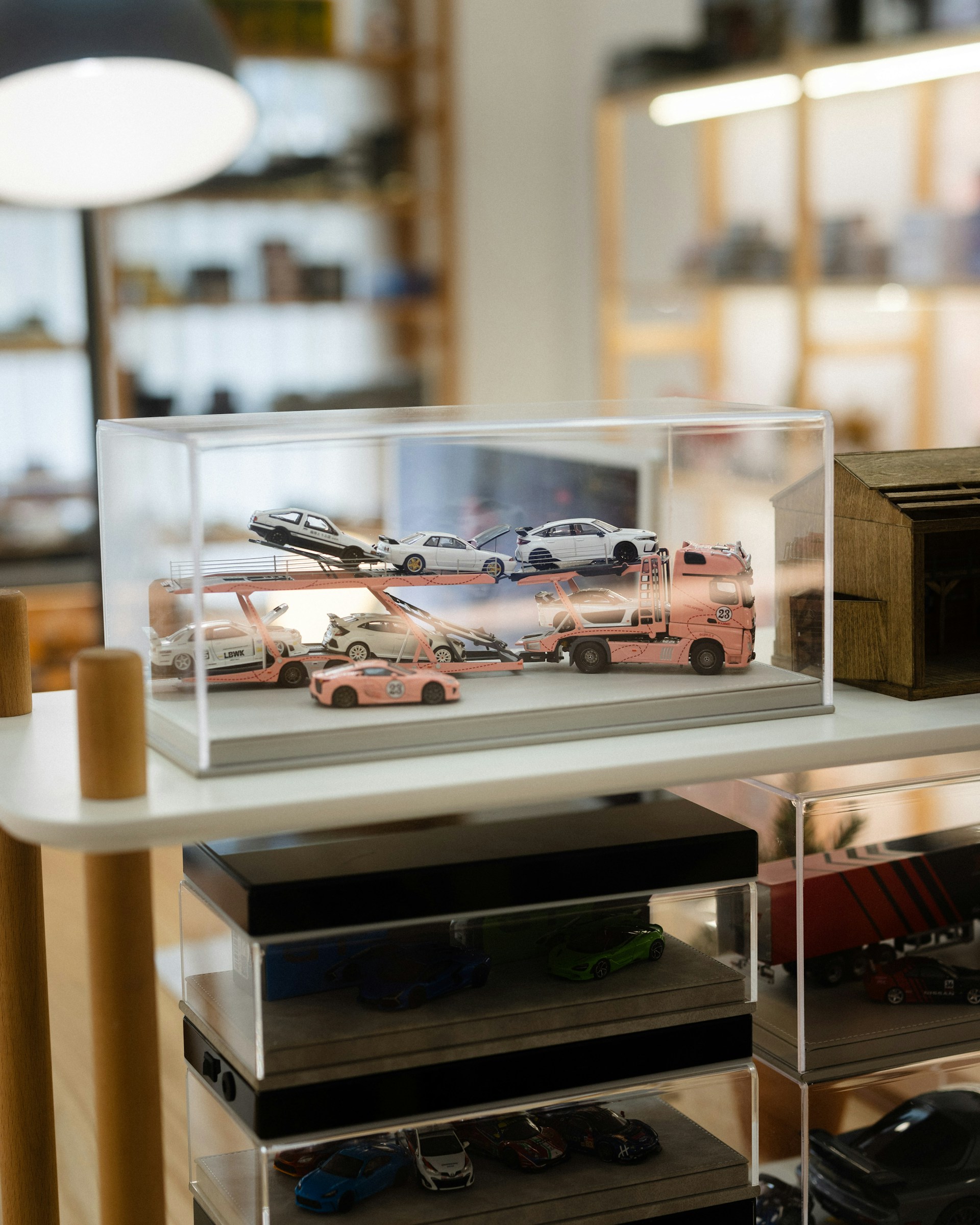 A display case with cars in it on a shelf