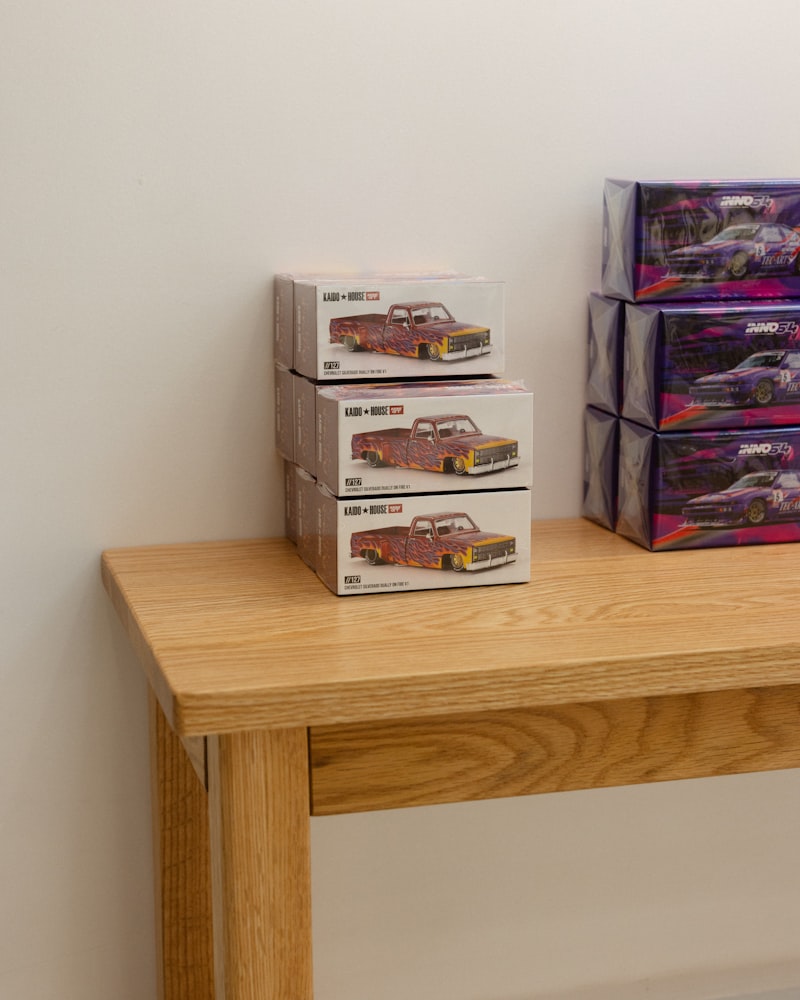 Premium boxed 1:64 releases stacked on a desk — the format that powered some of the biggest 2025 flips