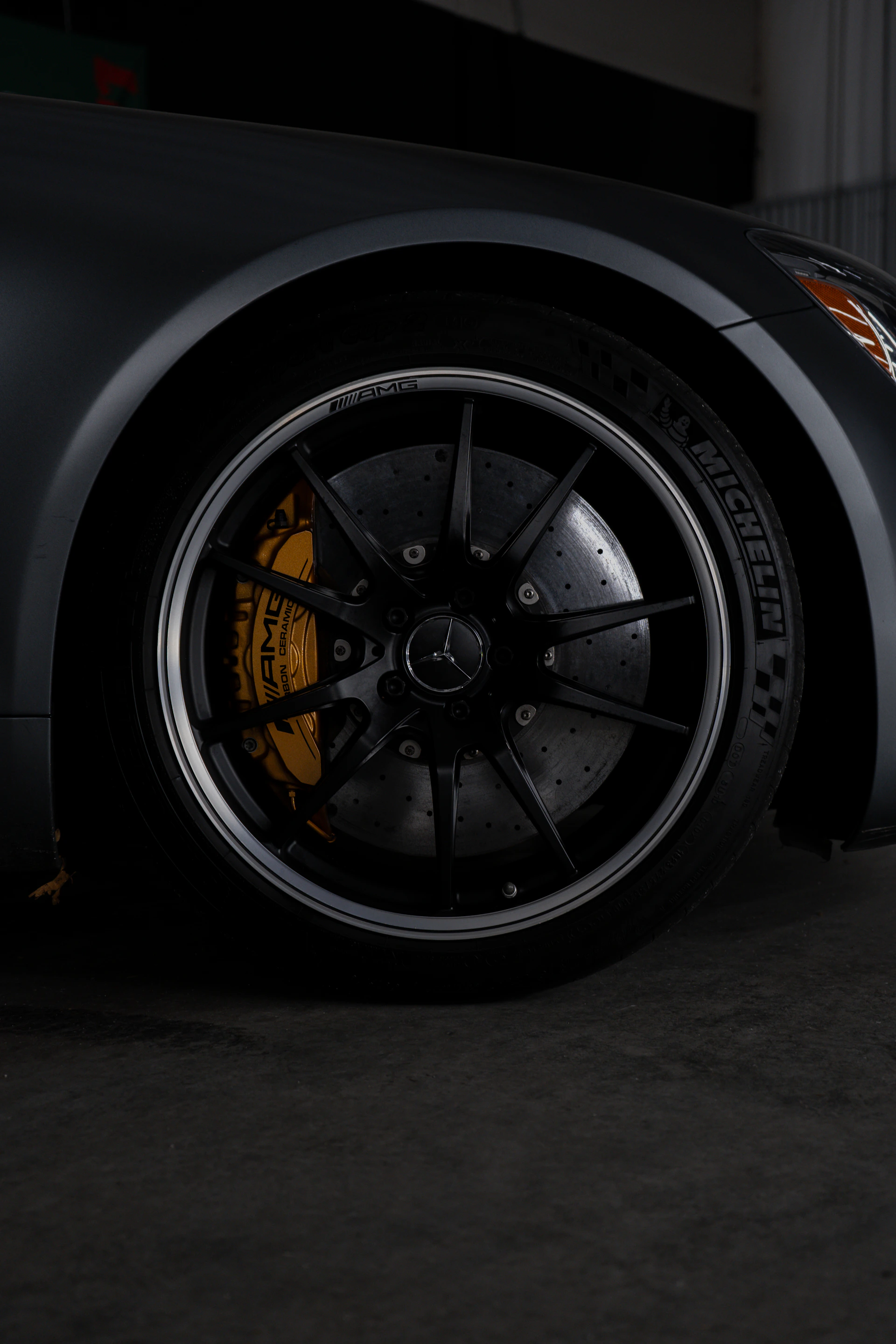 A black sports car parked in a garage