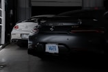 A couple of cars are parked in a garage