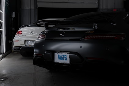 A couple of cars are parked in a garage