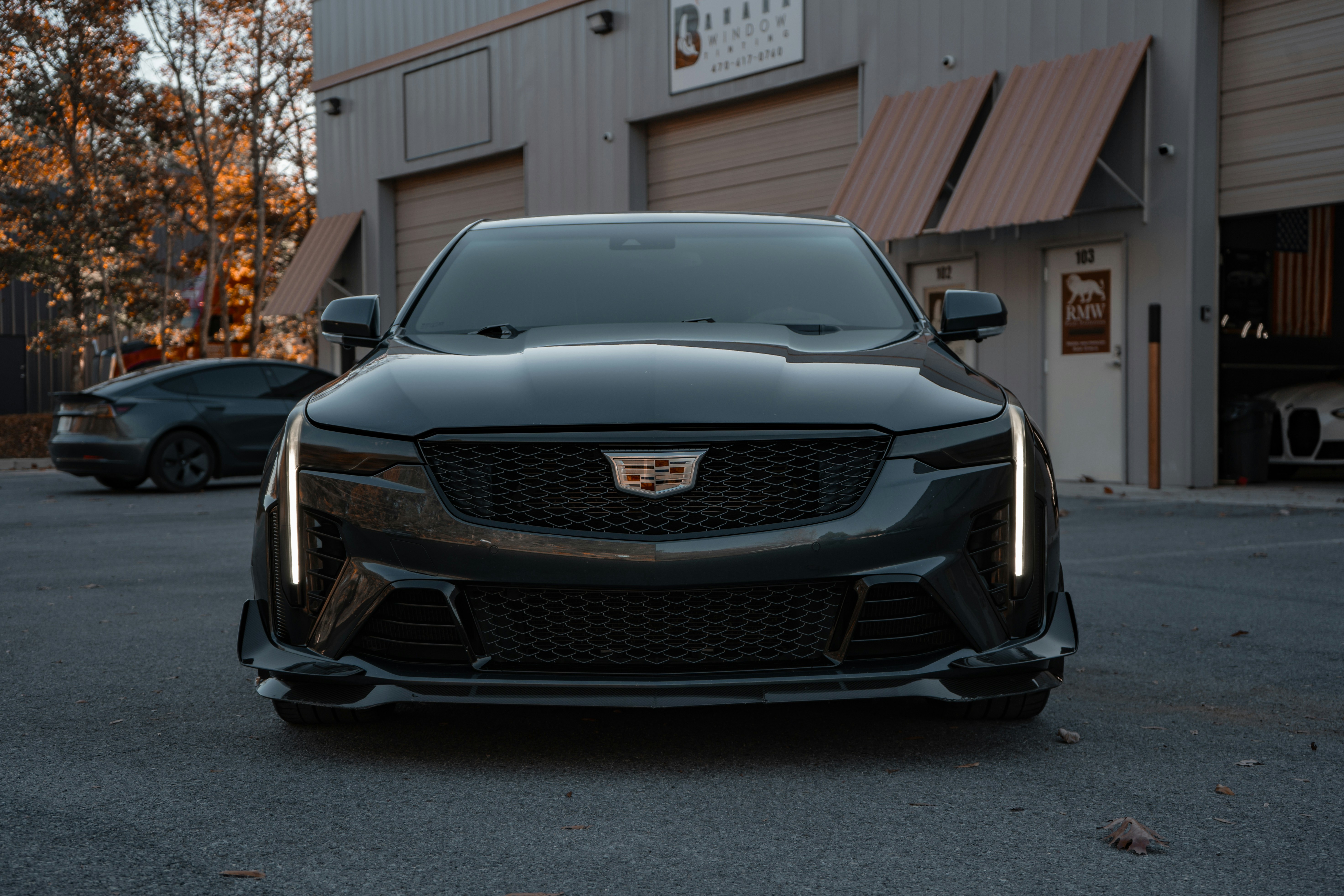 A black car parked in front of a building