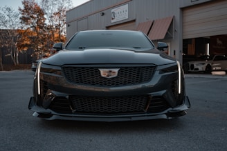 A black cadillac parked in front of a building