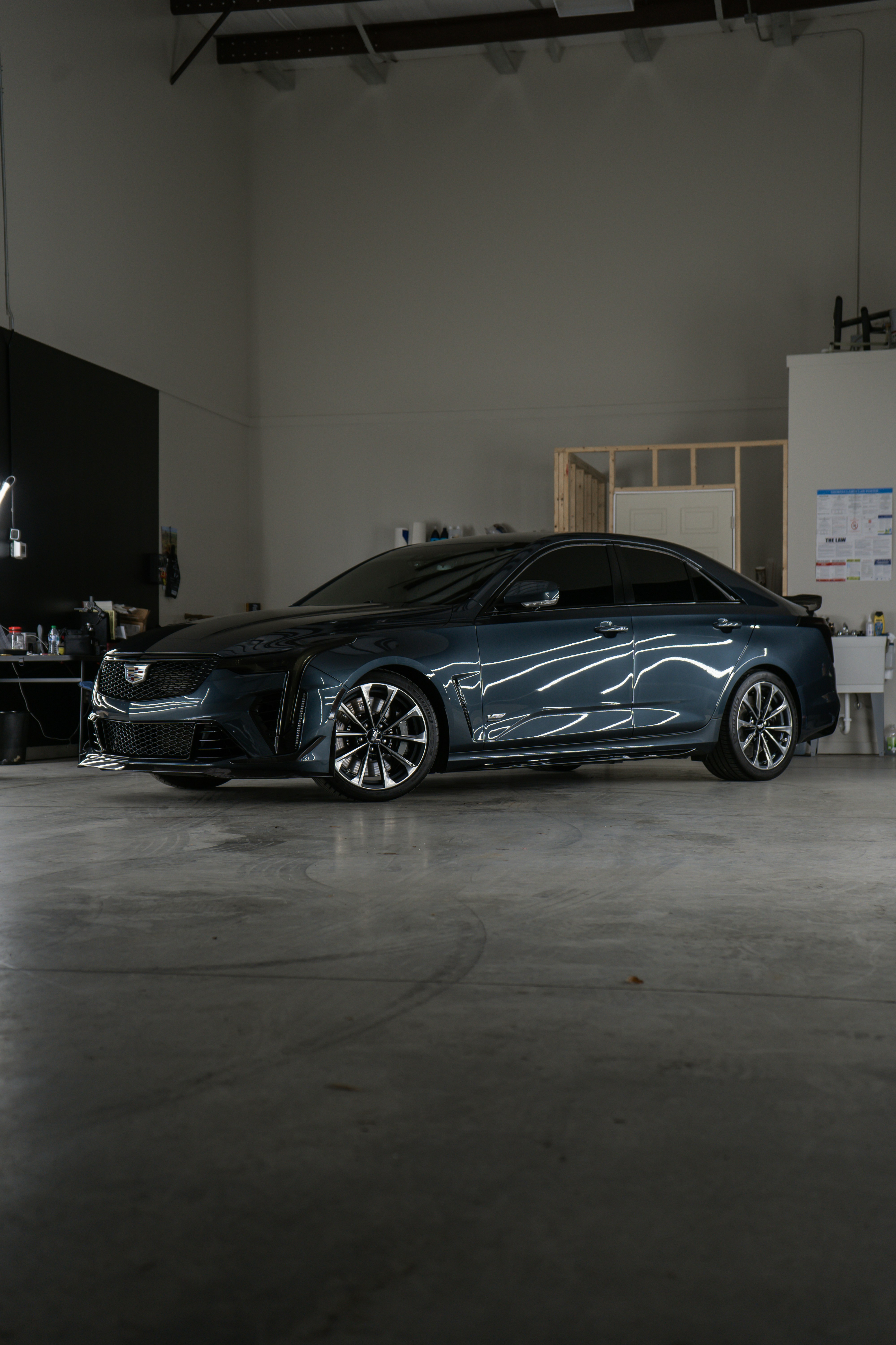 A car parked inside of a garage next to a wall