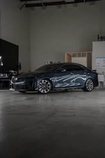 A car parked inside of a garage next to a wall