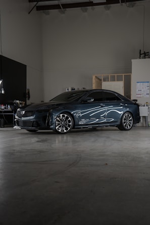 A car parked inside of a garage next to a wall