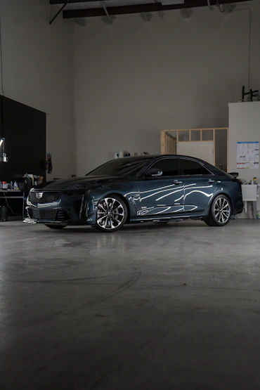 A car parked inside of a garage next to a wall