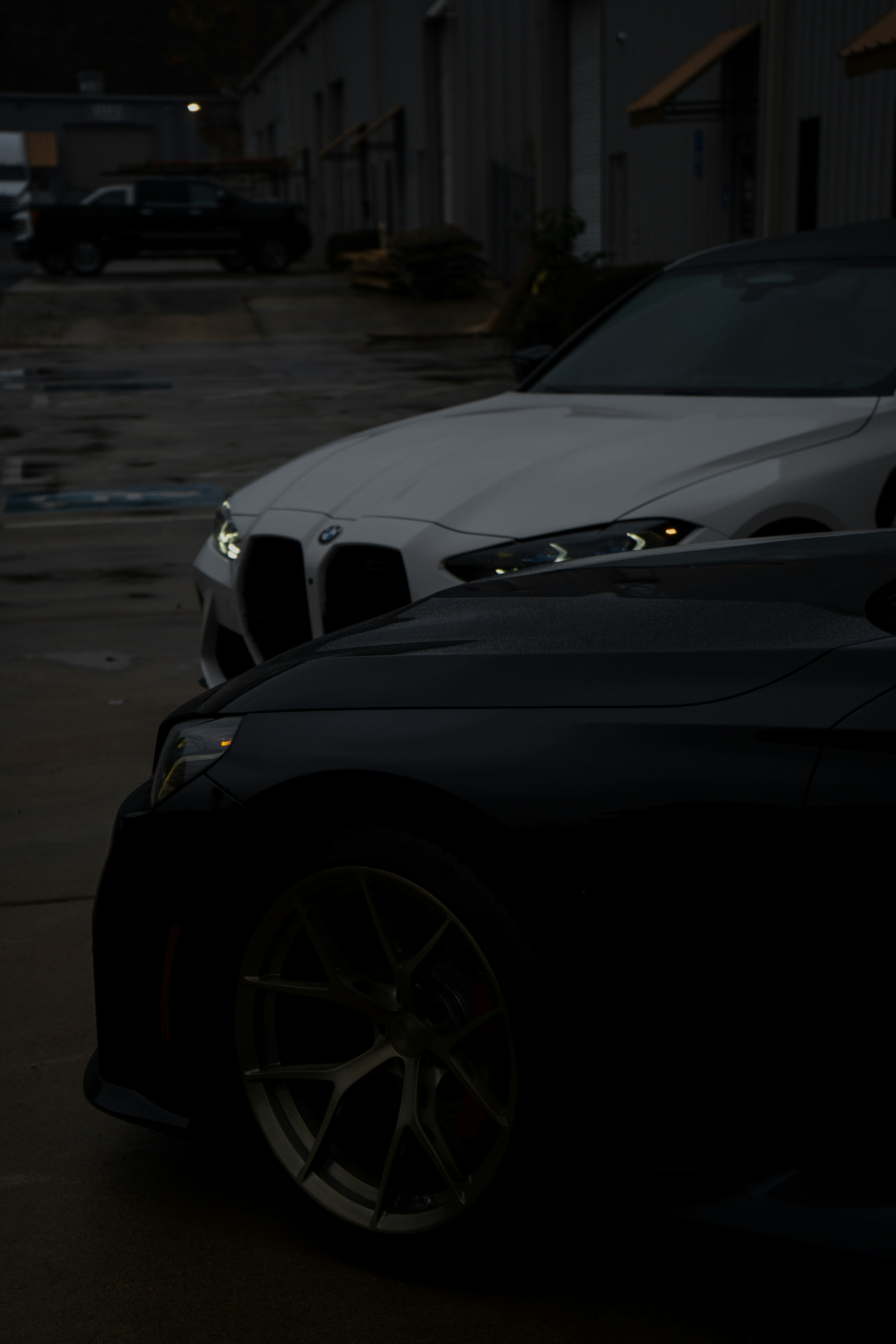 Two cars parked next to each other in a parking lot