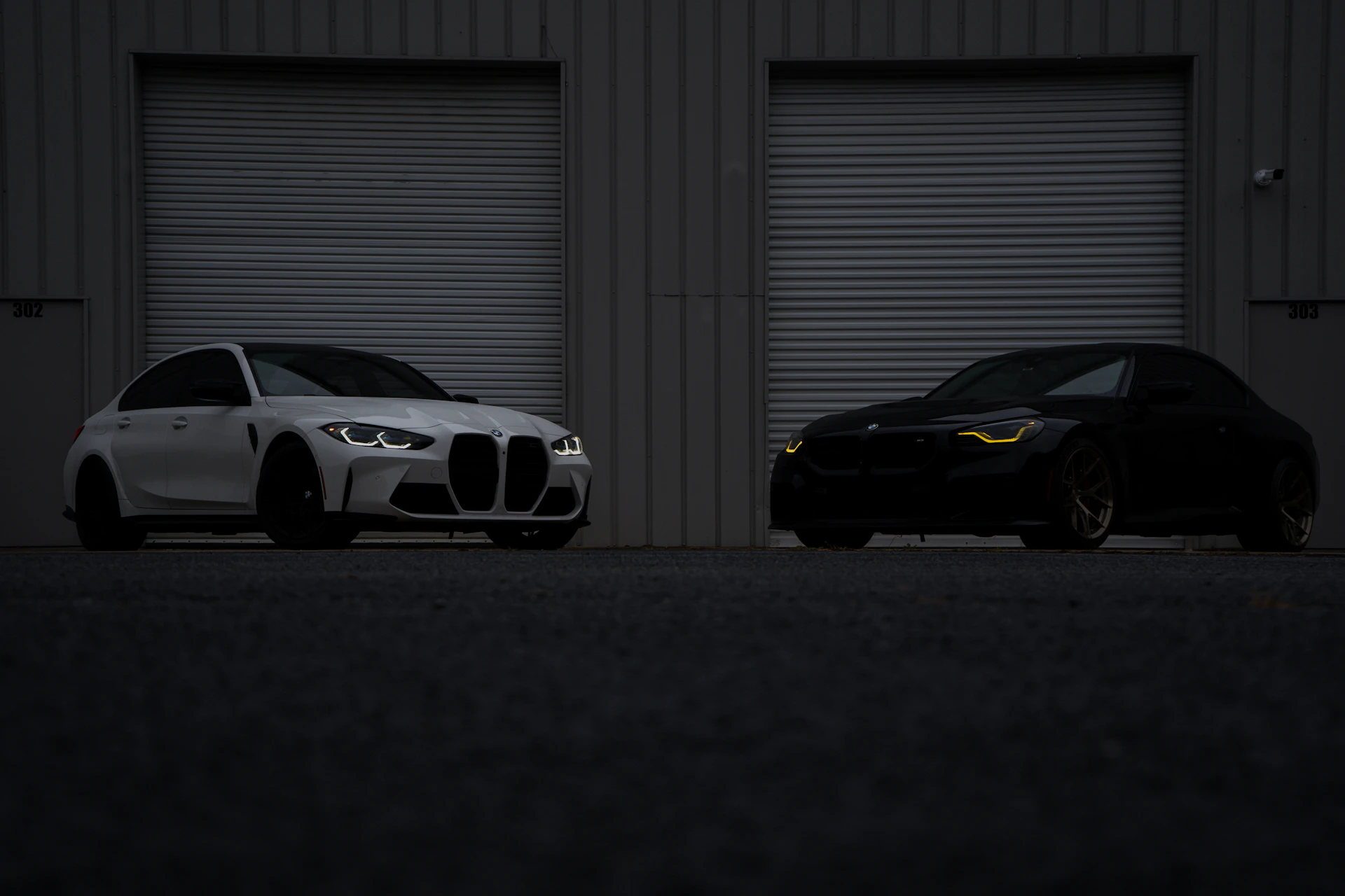 Two cars parked next to each other in front of a building