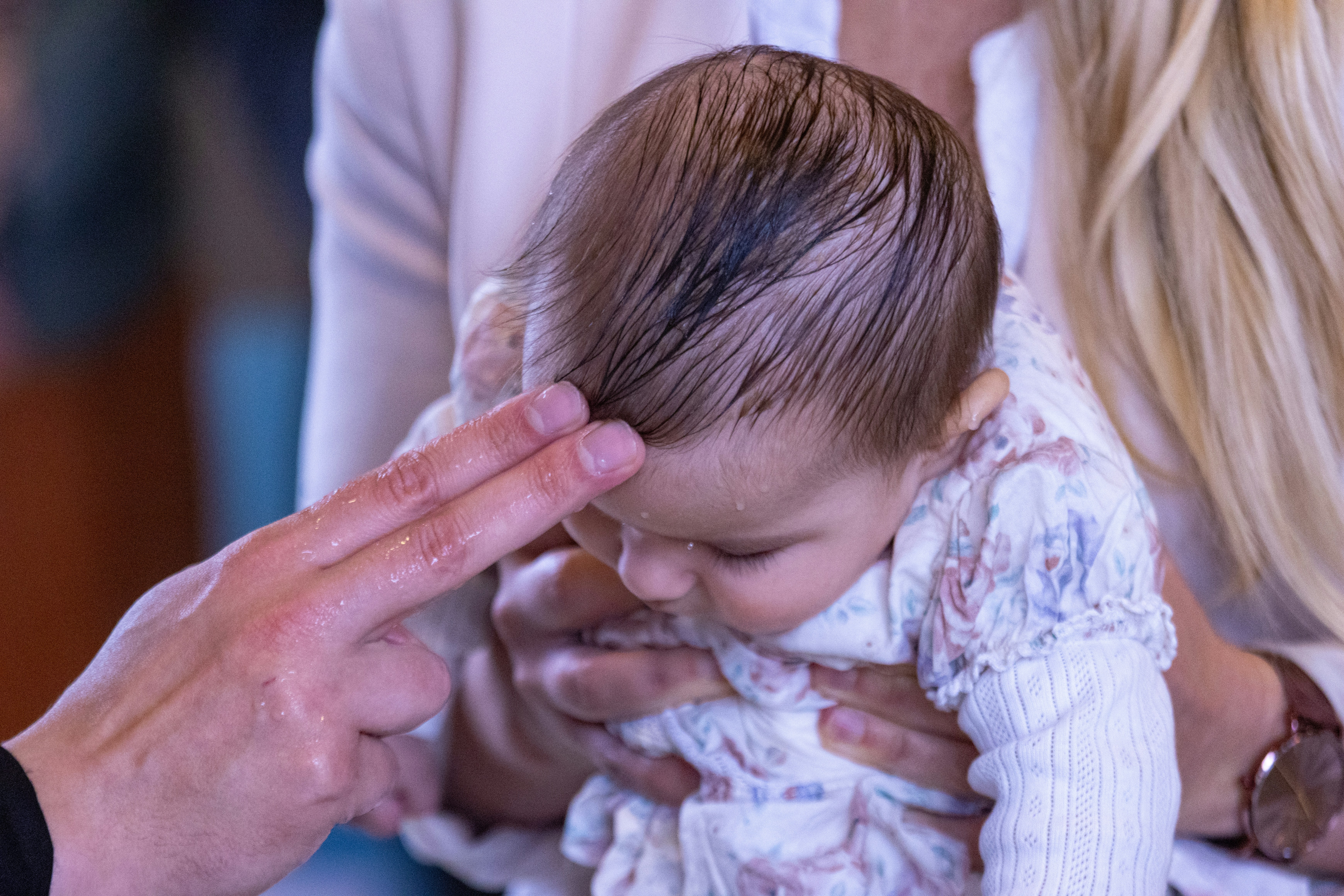 A woman holding a baby in her arms