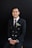 A man in a suit and tie posing for a picture