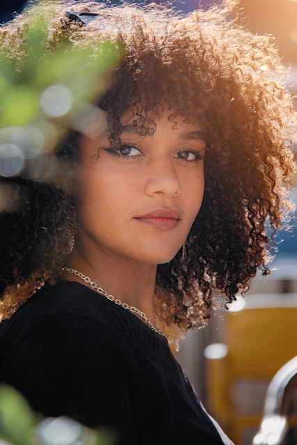 A close up of a person with curly hair