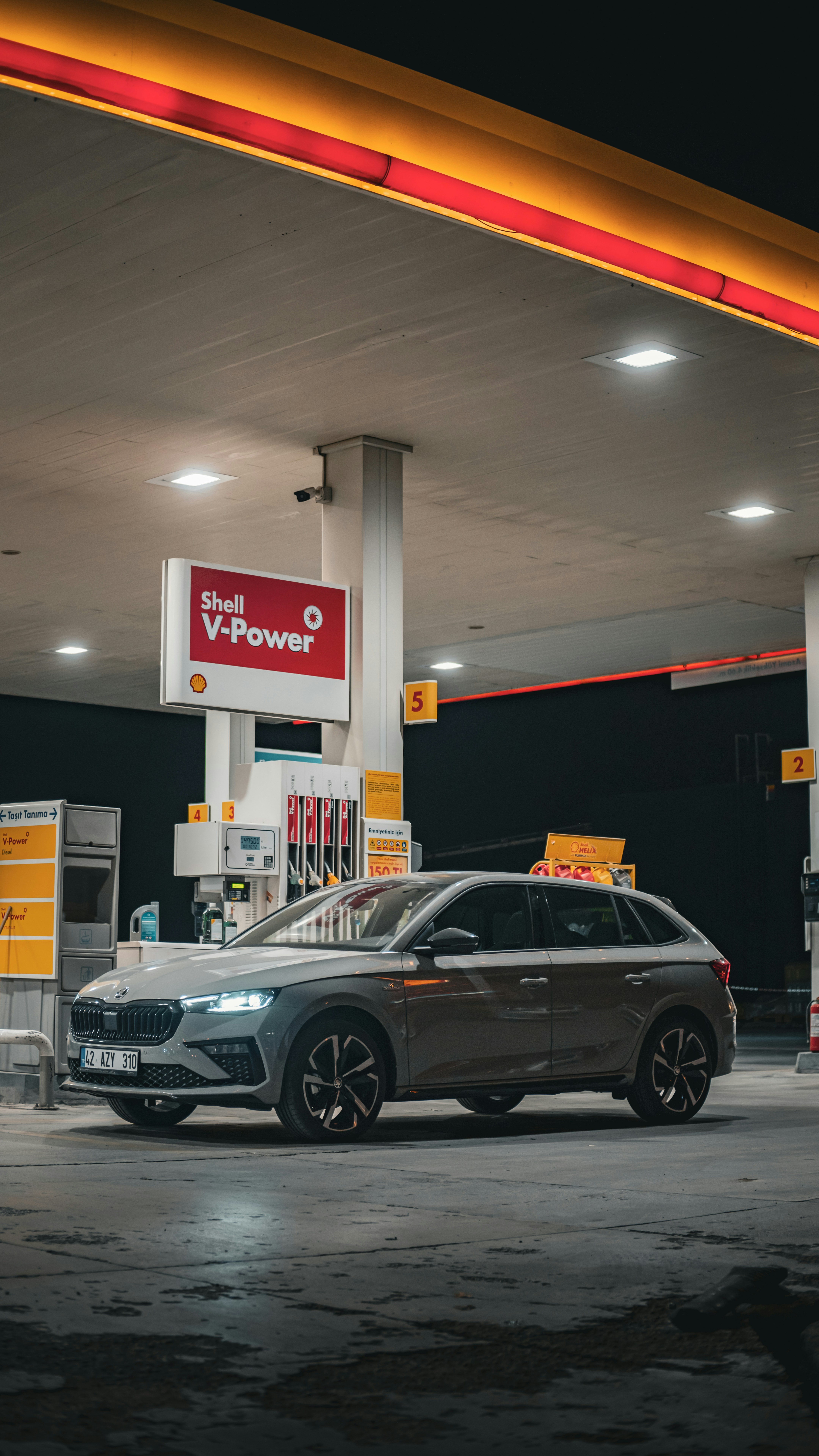 A car is parked in front of a gas station