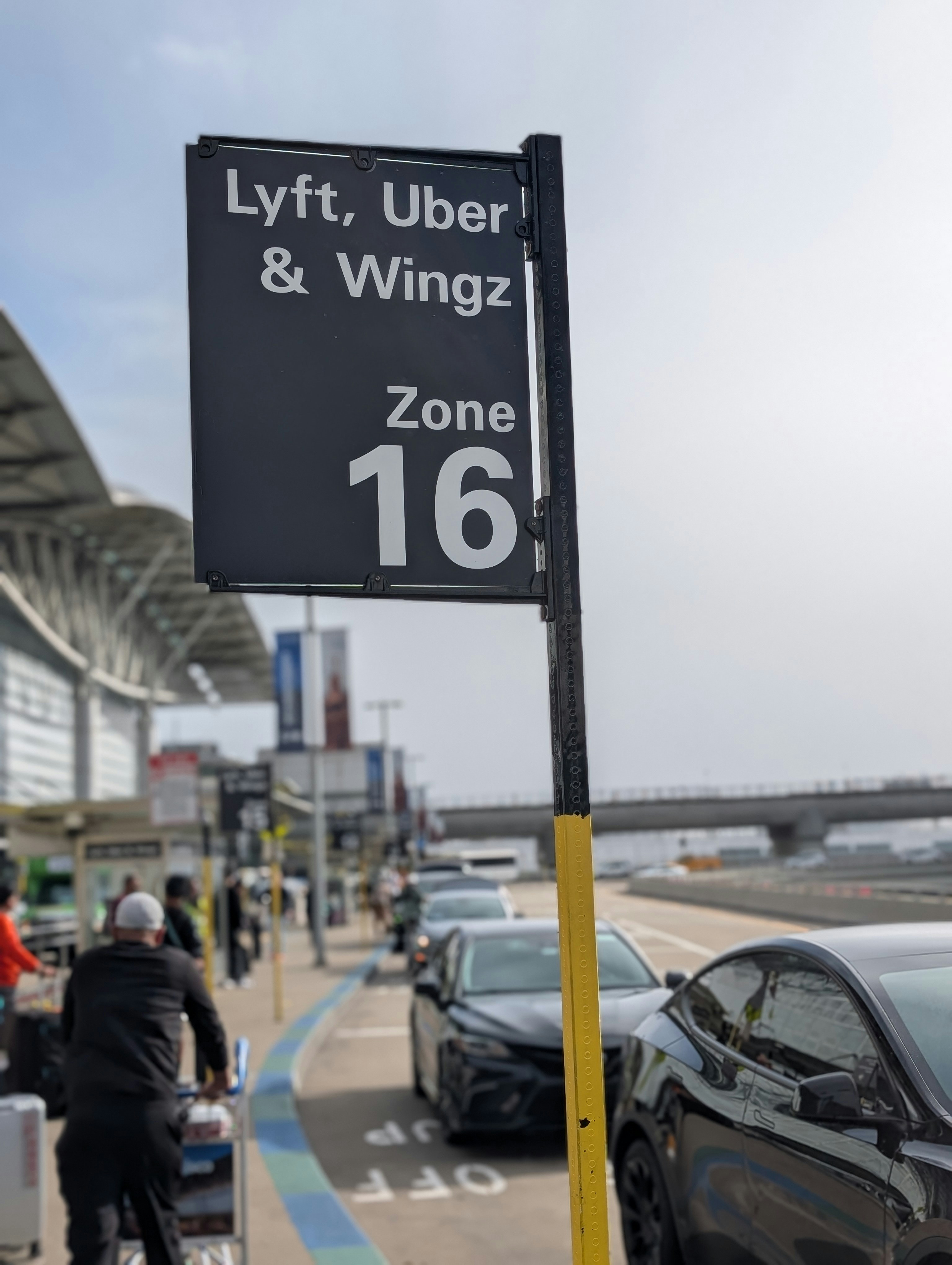 A sign signaling the pick-up location for ride share drivers, who are a major component of the gig economy.