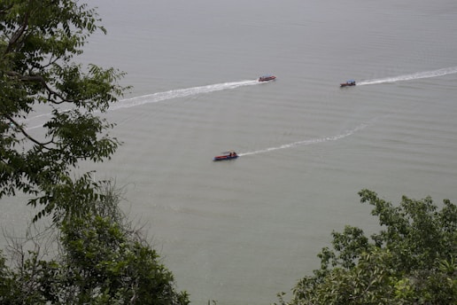 A group of boats traveling across a large body of water