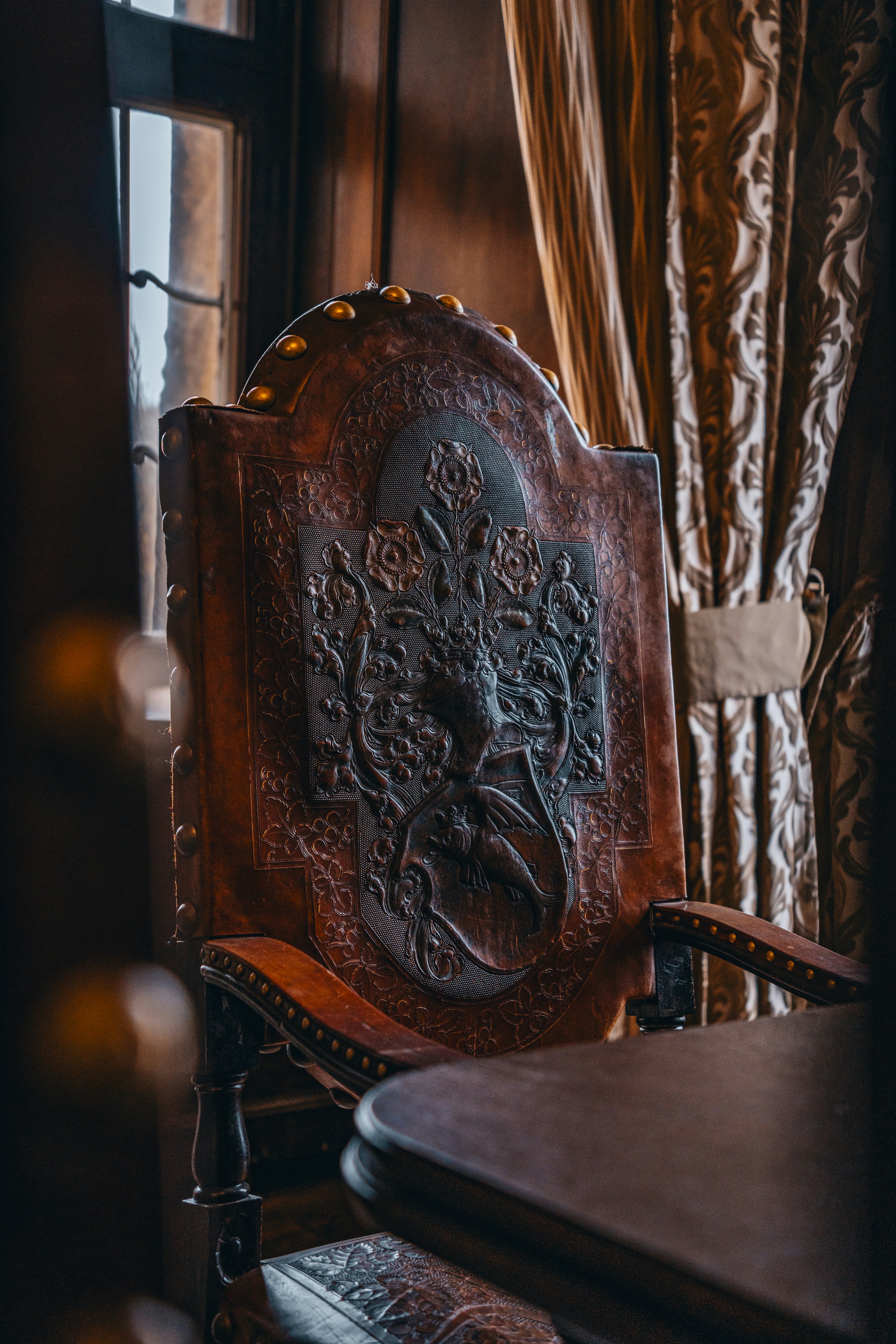 A wooden chair sitting in front of a window