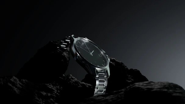 A watch sitting on a rock in the dark