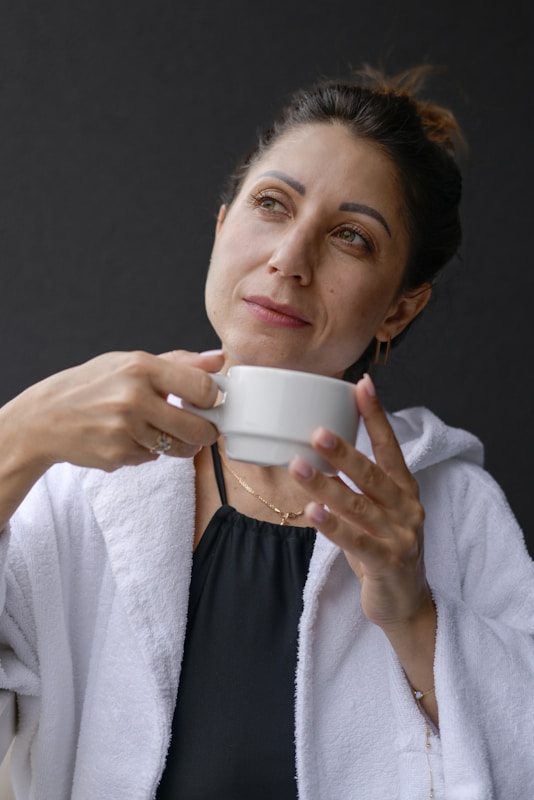 A woman is holding a cup of coffee