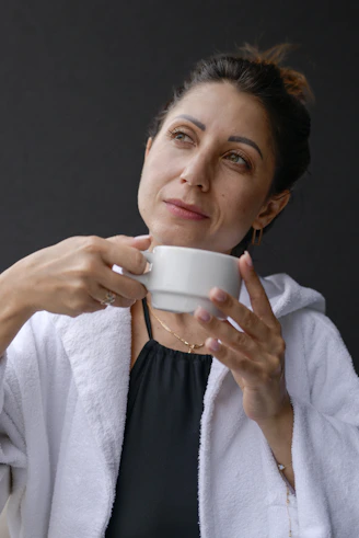 A woman is holding a cup of coffee