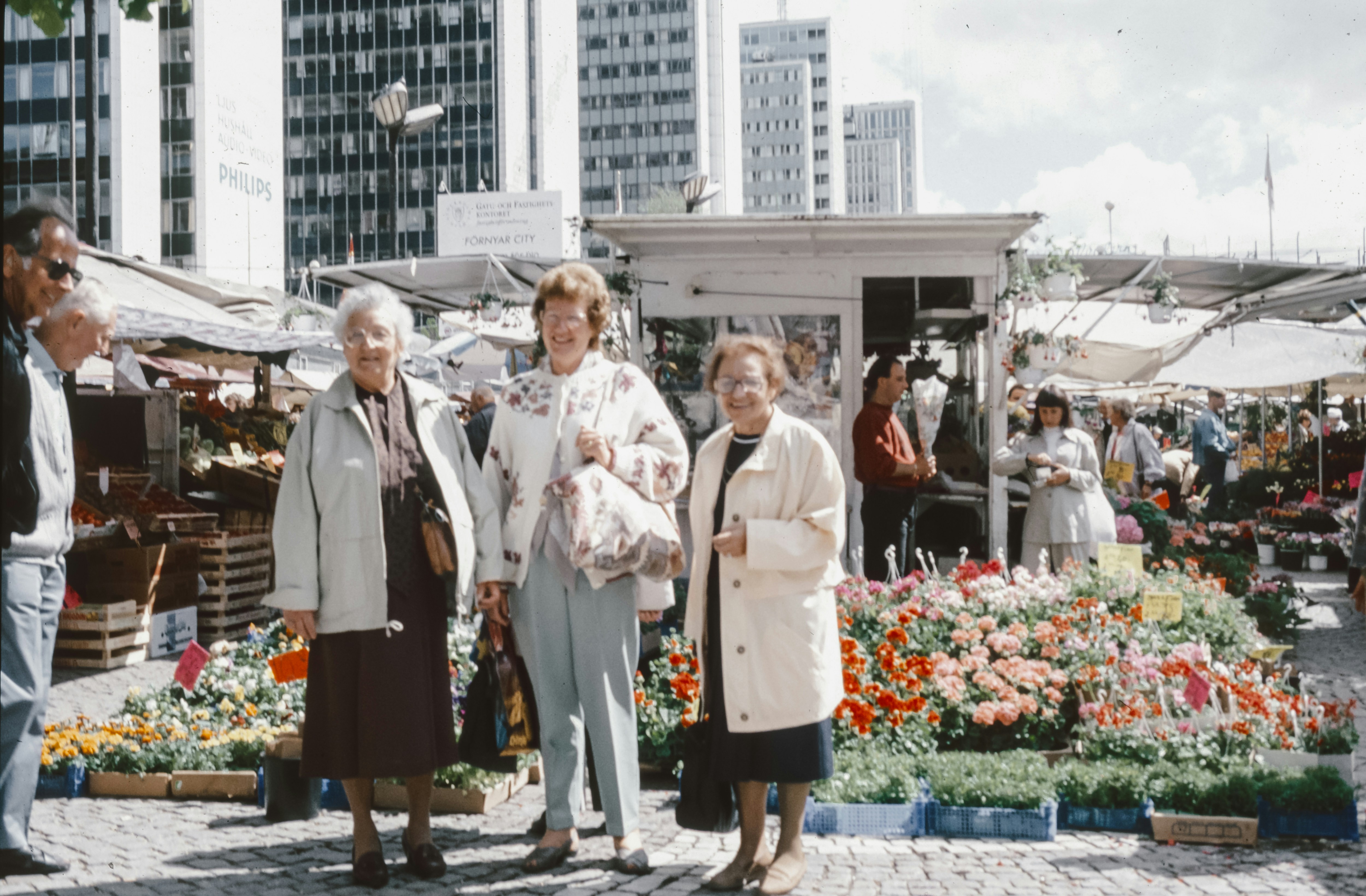 A group of people standing around a flower market photo – Free Vintage ...