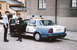 A police officer standing next to a police car