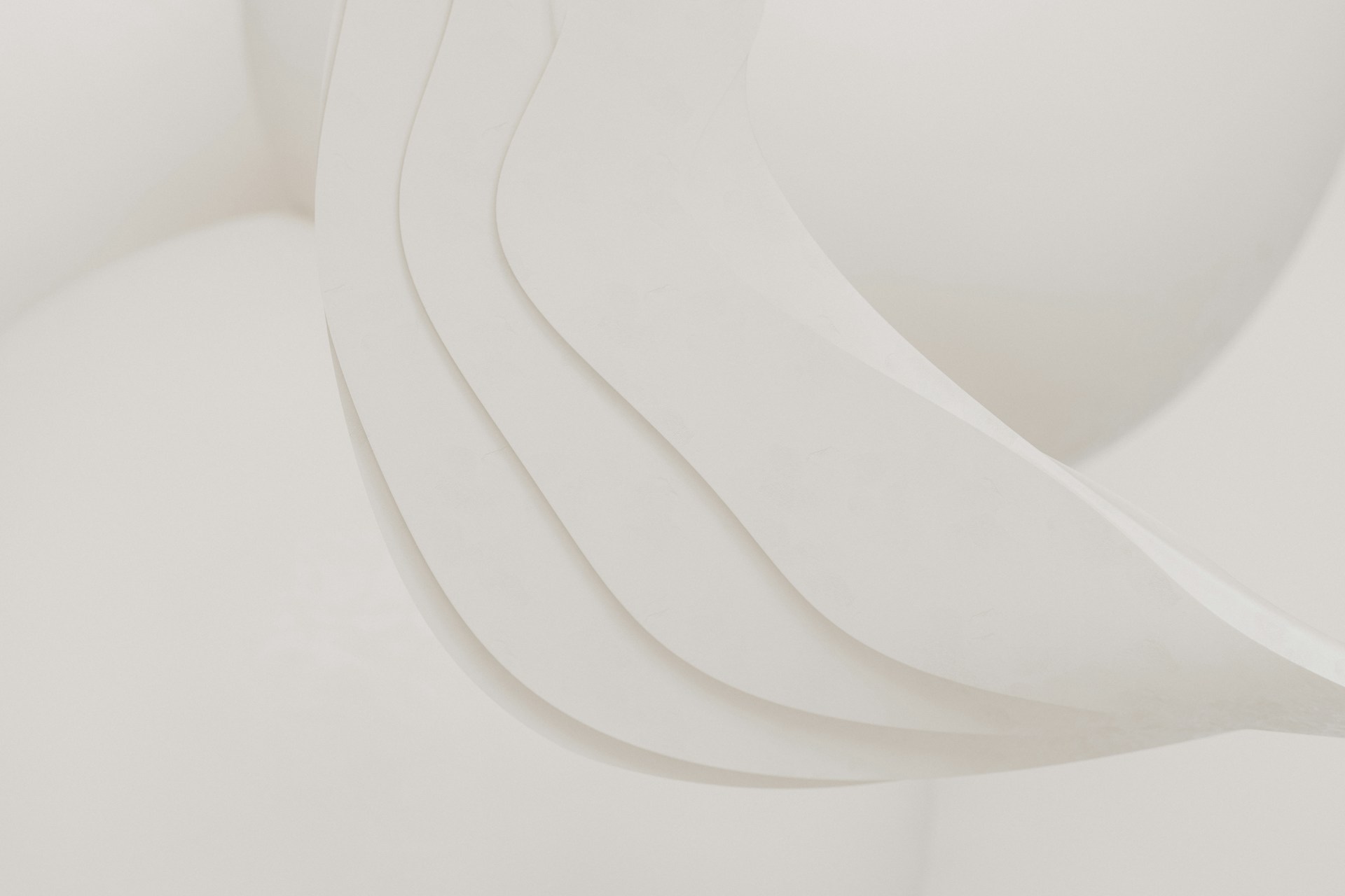 A close up of a white sculpture with curved lines