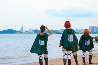 A group of people standing on top of a sandy beach