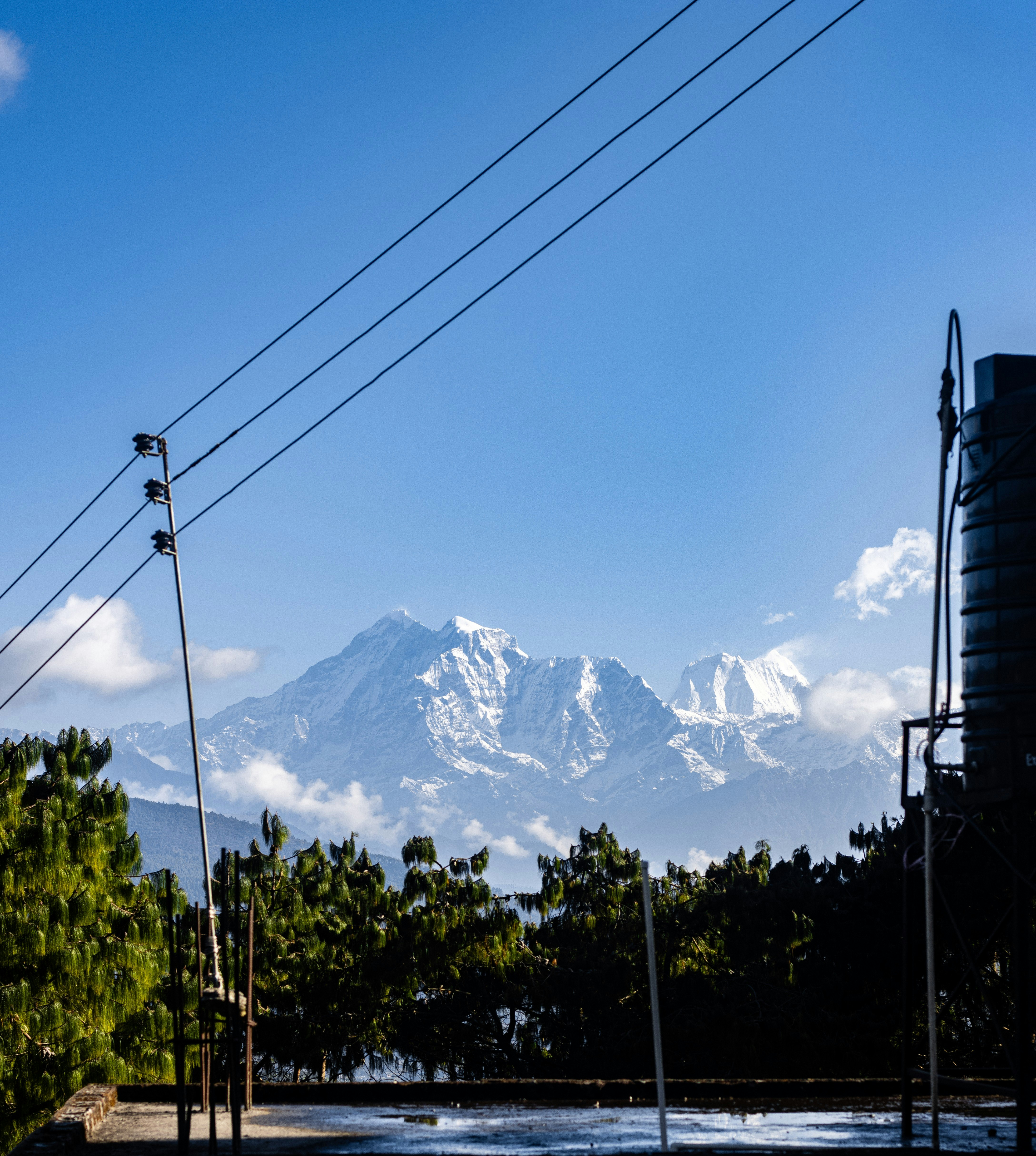 A view of a mountain range with power lines in the foreground