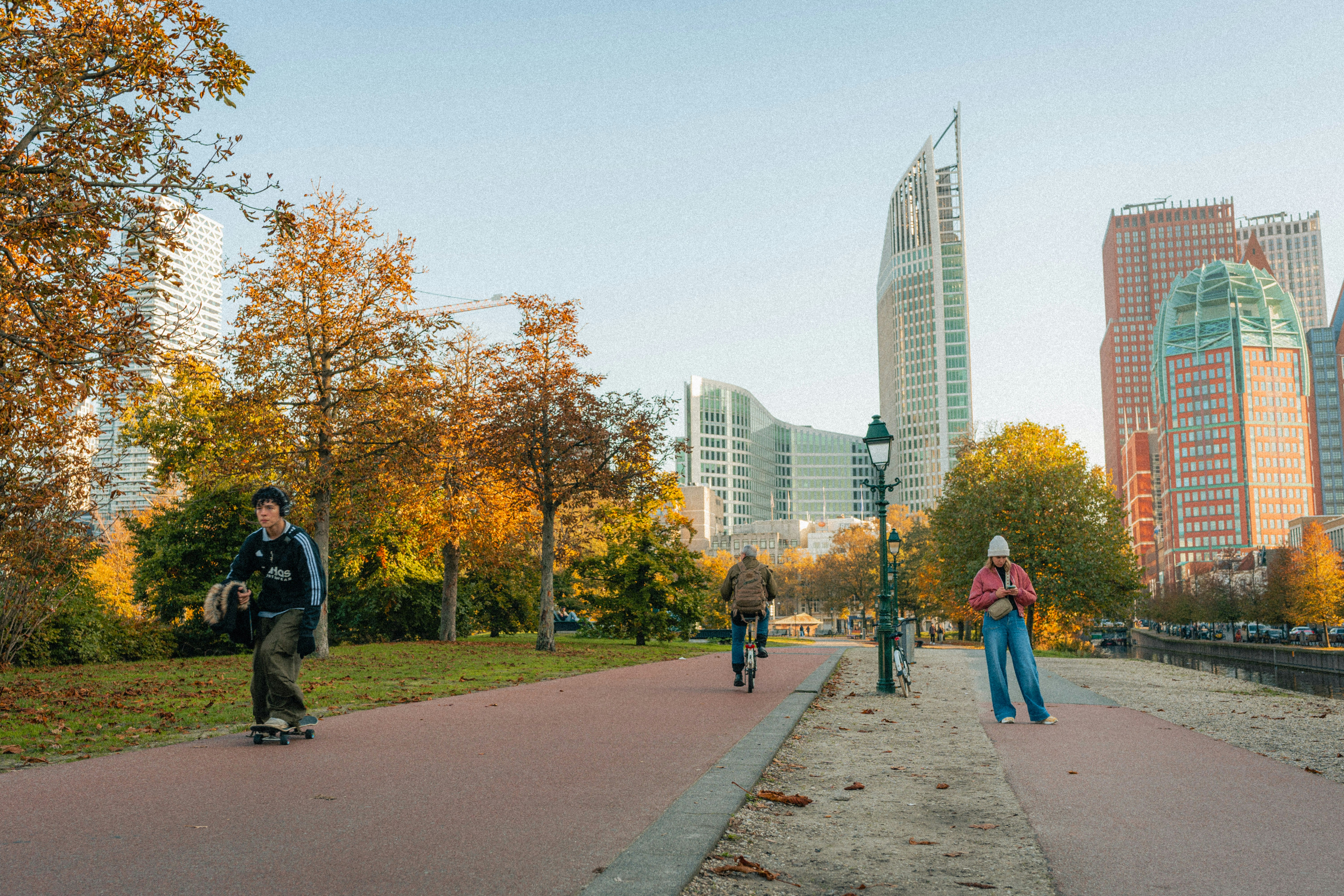 A group of people riding skateboards down a sidewalk