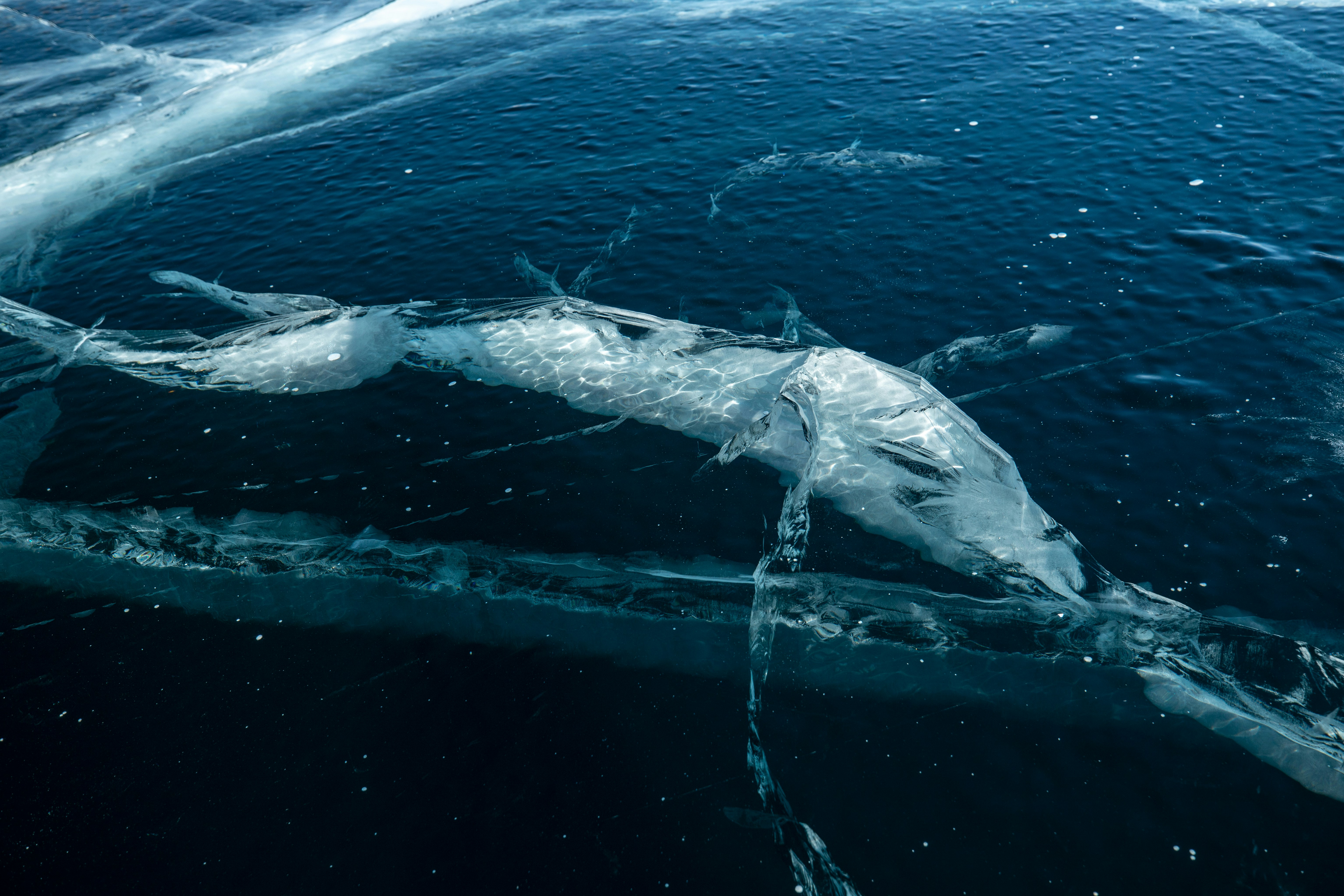 A boat in a body of water surrounded by ice