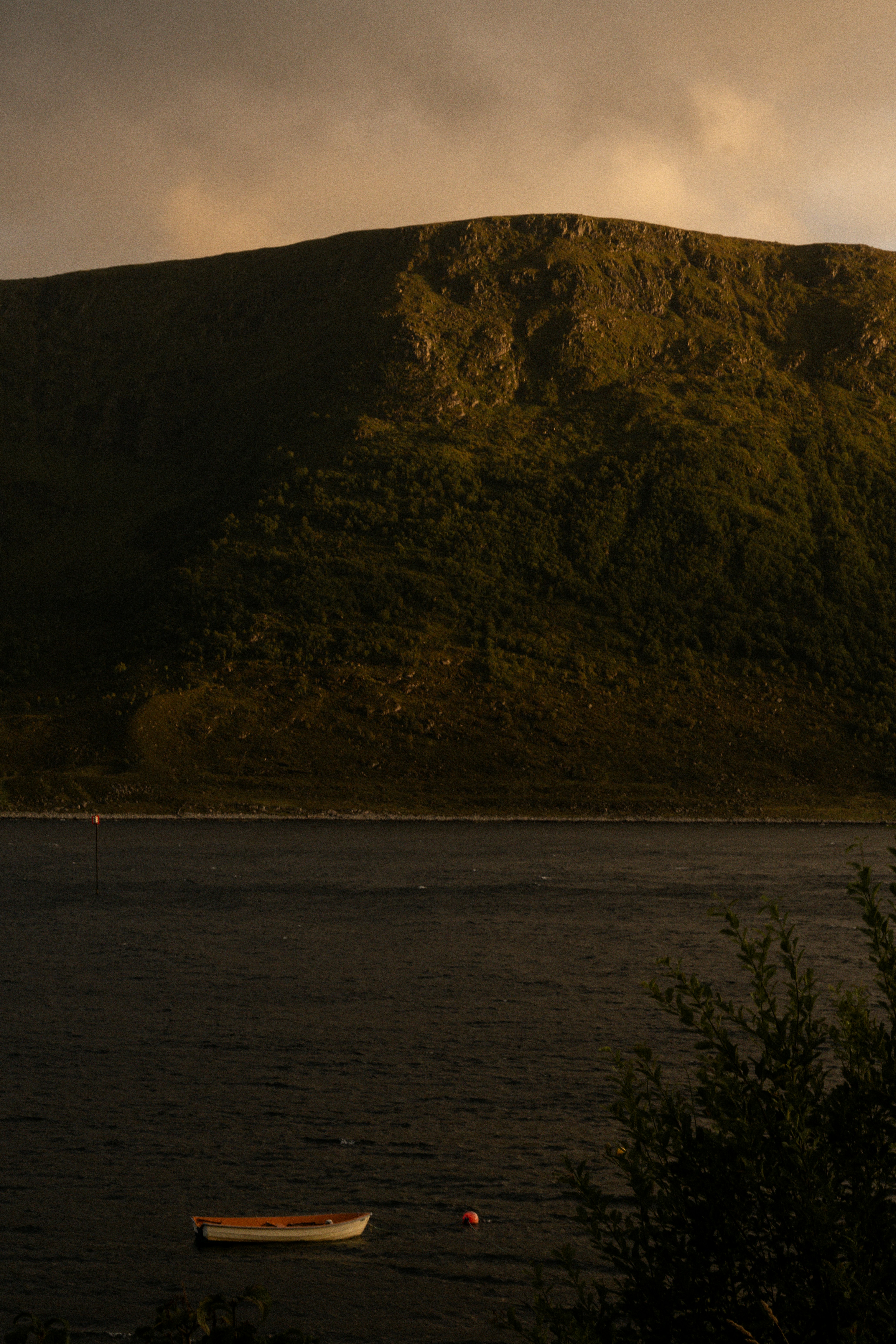 A boat on the water with a mountain in the background