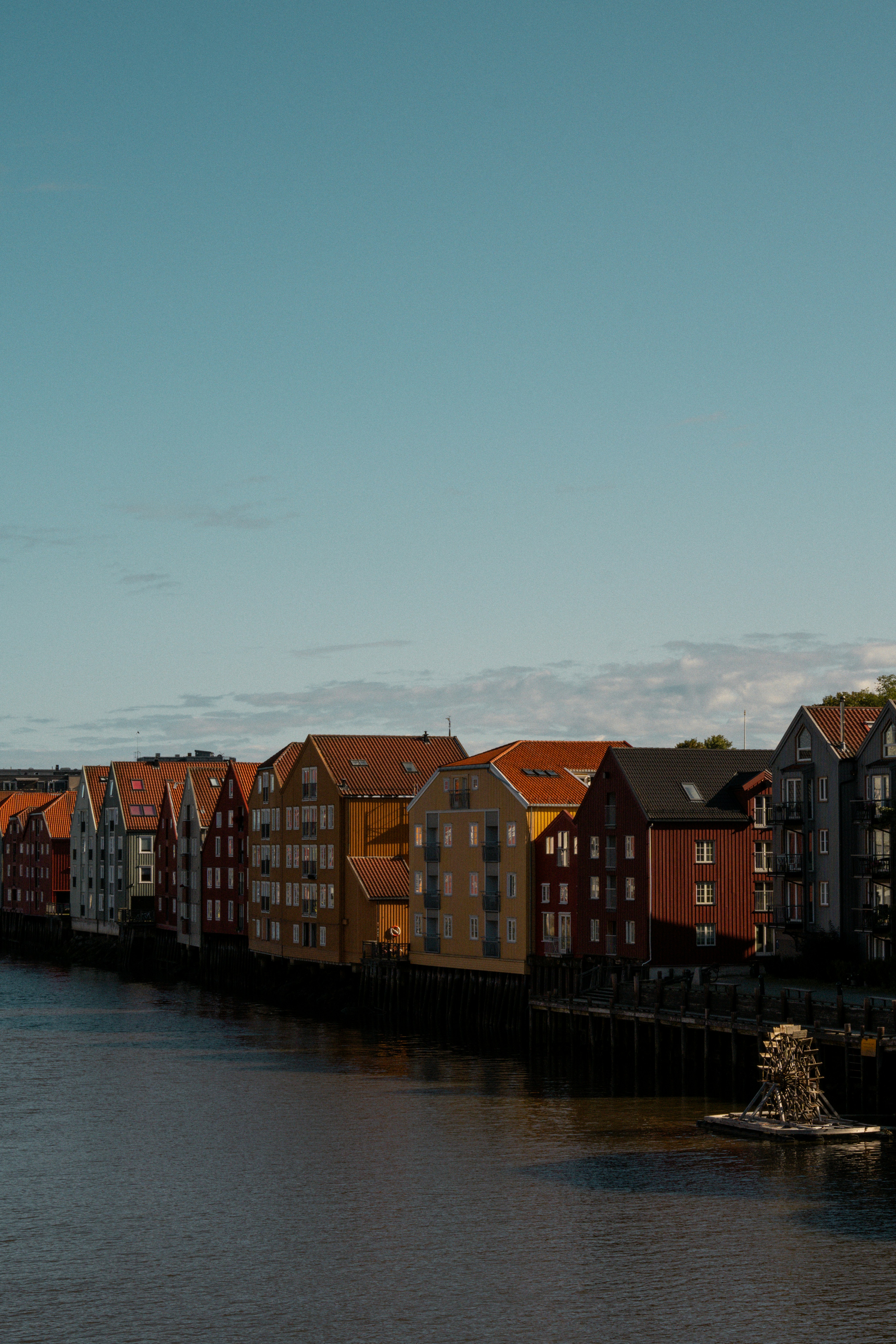 A row of houses on the side of a river