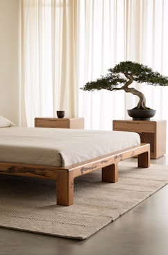 A bedroom with a bed and a bonsai tree
