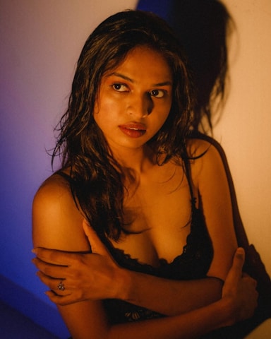 A woman in a bra posing for a picture