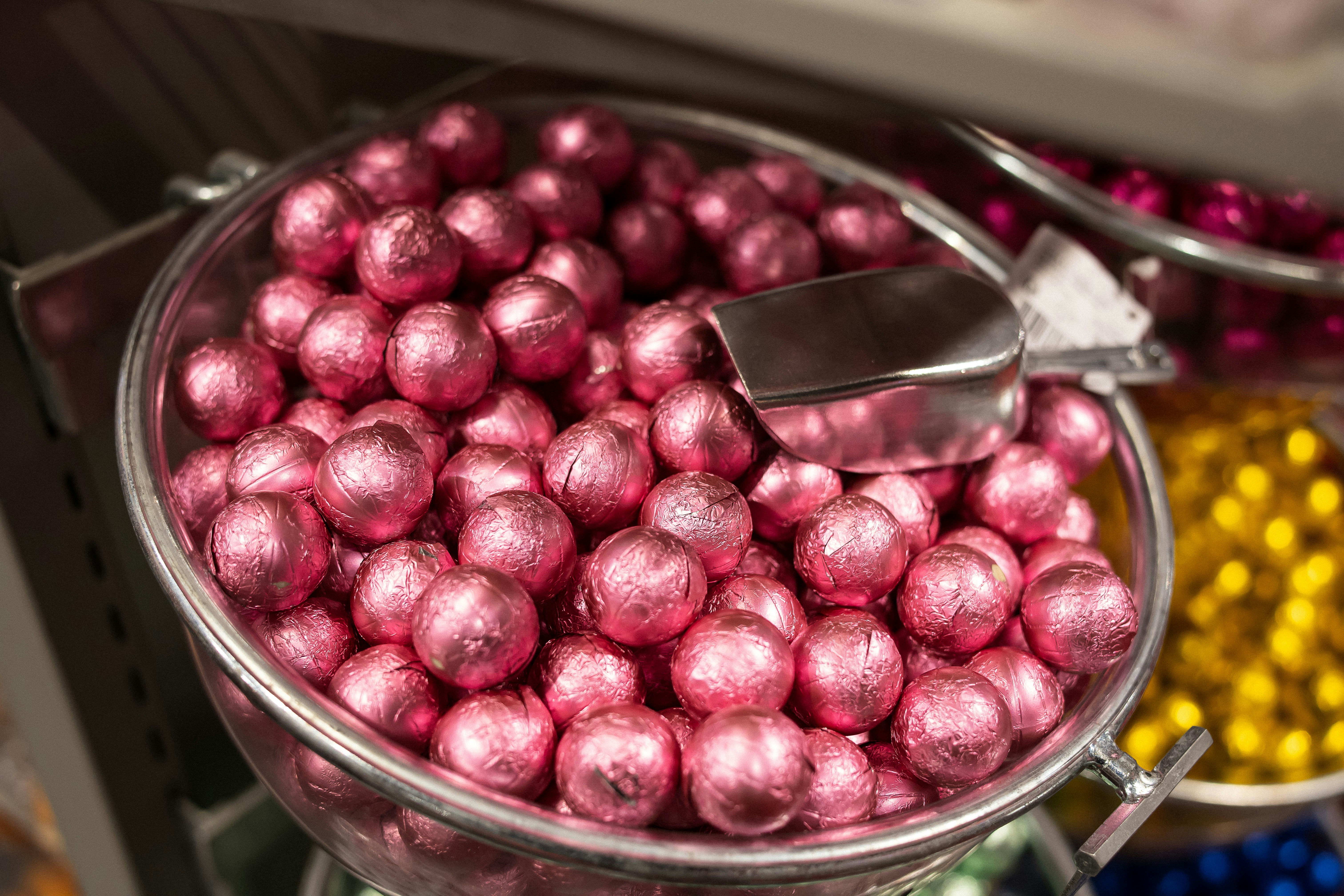 A large metal bowl filled with lots of candy