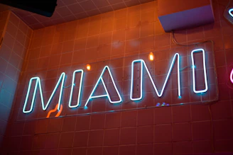 A neon sign on the wall of a restaurant