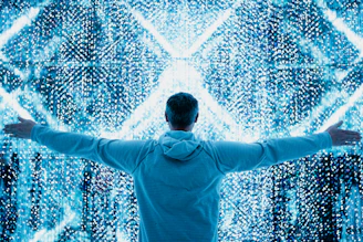 A man standing in front of a large display of numbers