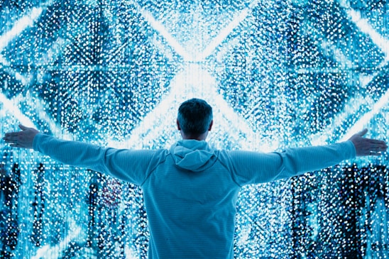 A man standing in front of a large display of numbers