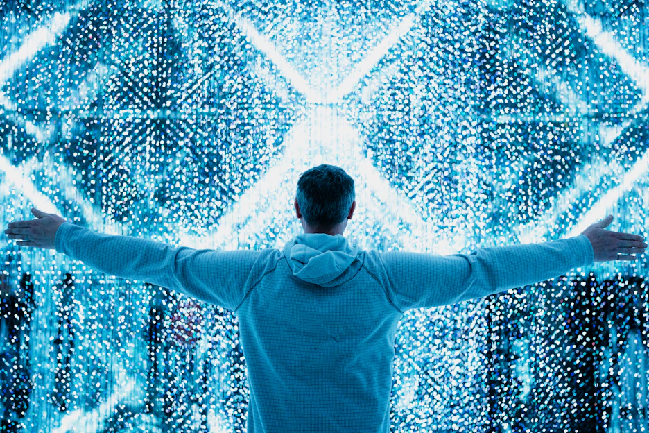 A man standing in front of a large display of numbers
